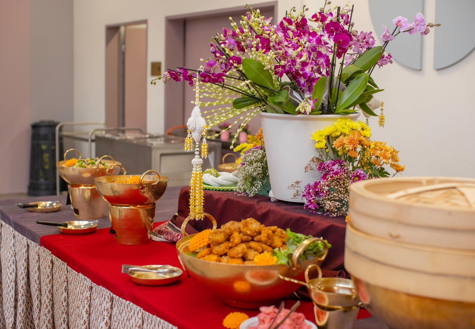 Buffet mit goldenen Schalen und Blumendekoration